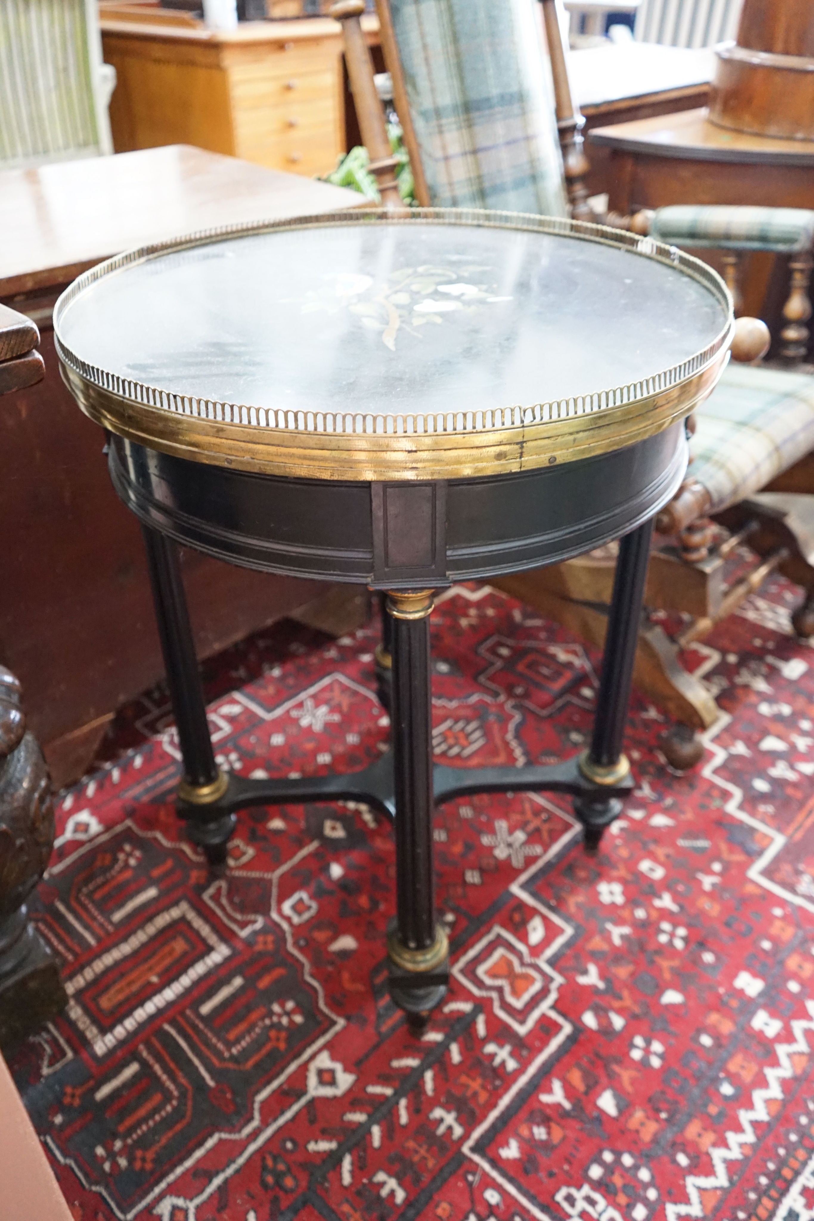 A Victorian circular gilt metal mounted ebonised centre table with pietra dura top, diameter 57cm, height 74cm